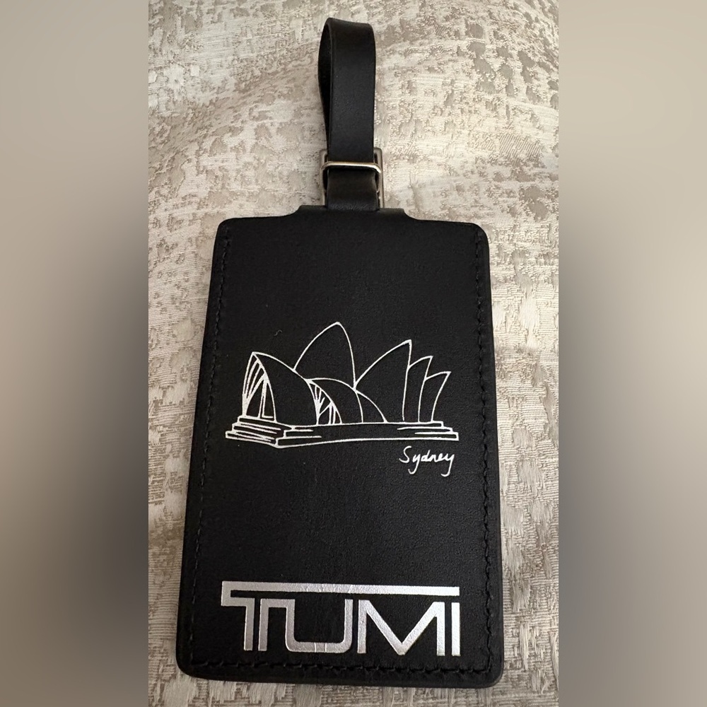 Black leather TUMI luggage tag embossed with Sydney Opera House